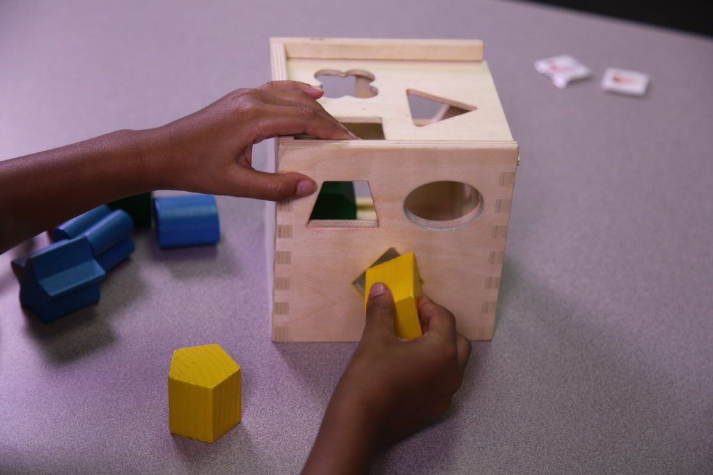 Special needs student using a shape sorter